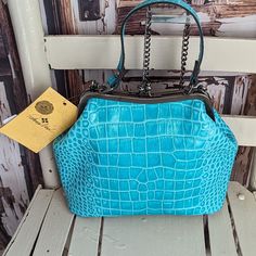 Turquoise Colored Croc Embossed Kiss In Lock Handbag. Antiqued Hardware. Nwt As Seen In Photos. Please Reference All Pictures They're An Important Part Of The Description And Sizing. All Reasonable Offers Welcomed. I Offer Same Day Ship Or Next Try Bundling For Savings On-the-go Blue Rectangular Satchel, Light Blue Top Handle Shoulder Bag, Luxury Turquoise Top Handle Bag, Luxury Turquoise Travel Bags, Light Blue Rectangular Bag With Removable Pouch, Light Blue Rectangular Shoulder Bag With Removable Pouch, Blue Bags With Top Carry Handle For On-the-go, Light Blue Top Handle Bag With Detachable Strap, Light Blue Tote Bag With Removable Pouch