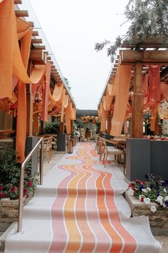 an orange and white striped carpet is on the steps leading up to a patio area