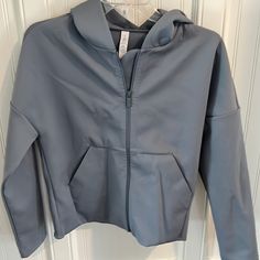 Zip Up Slate Blue Soft Jacket. 2 Front Pockets 56% Nylon, 44% Elastane. Excellent Condition. Loose Fit. No Stains. Never Worn Blue Moisture-wicking Outerwear For Workout, Moisture-wicking Blue Outerwear For Workout, Blue Hooded Outerwear For Workout, Gray Hooded Outerwear For Workout, Blue Sportswear Outerwear For Workout, Soft Jacket, Blue Soft, Slate Blue, Blue Jacket