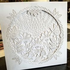 a white card with an intricate design on it