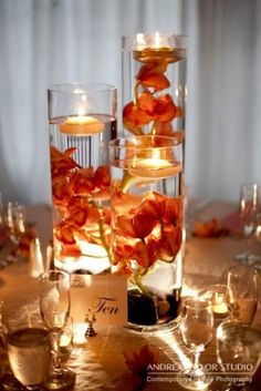 the centerpieces are filled with candles and flowers