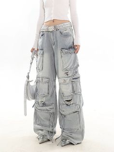 Experience the ultimate blend of streetwise flair and classic comfort with our Distressed Wide-Leg Denim Cargo Pants.Made with premium denim, these pants boast a relaxed wide-leg fit and a natural waist design, providing a comfortable experience without compromising on style. The distressed details and multiple pockets echo a laid-back vibe while adding practicality and edge to your look. These versatile pants serve as the perfect canvas for a variety of styling options – pair them with a sleek Y2k Wide Leg Flare Jeans With Pockets, Y2k Style Wide Leg Flare Jeans With Pockets, Wide-leg Jeans For Streetwear In Medium Wash, Fall Denim Wide Leg Pants For Streetwear, Streetwear Denim Wide Leg Pants, Dark Wash Wide-leg Flare Jeans For Streetwear, Y2k Style Wide Leg Jeans With Cargo Pockets, Wide Leg Denim Pants For Streetwear, Wide Leg Jeans For Streetwear