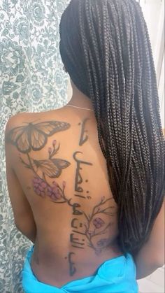 a woman with butterfly tattoos on her back