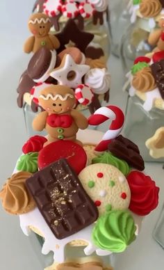 cupcakes decorated with different types of cookies and candies are lined up in rows