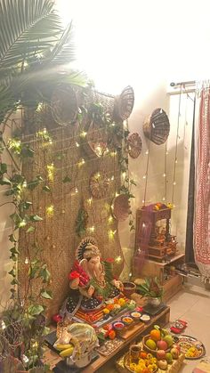 an assortment of fruits and vegetables on display in a room decorated with wicker wall hangings