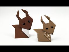 two origami deers are standing next to each other