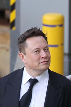 a man in a suit and tie looking off into the distance