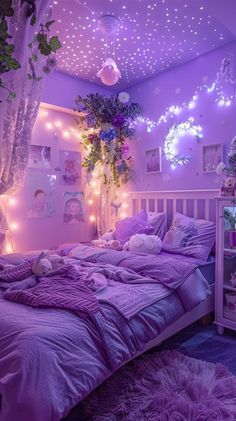 a bedroom decorated in purple and white with fairy lights