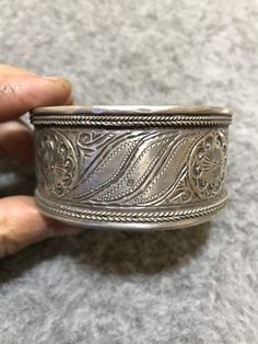 This is an silver berber bracelets from Morocco have a beautiful hand-scribed design. This bracelet is perfectly smooth and very worn from many years of wear. This bracelet with beautiful engraved decoration and good condition. Inner Diameter : 6,7cm Width : 3,3cm Weight : 74,7g Silver Artisan Bangle With Intricate Design, Traditional Silver Bracelet Stamped 925, Traditional Silver Stamped Bangle, Traditional Sterling Silver Bangle Bracelet Stamped 925, Traditional Silver Stamped Bracelets, Traditional Silver Stamped Bracelet, Traditional Stamped Bracelets, Traditional Silver Cuff Bracelet Stamped 925, Traditional Stamped Sterling Silver Bangle