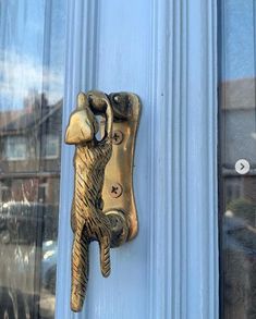 a close up of a door handle on a blue door