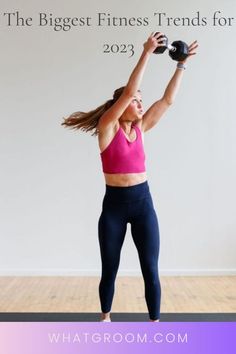 a woman in pink top and black leggings doing exercises with dumbbell exercise ball