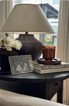 a lamp and some books on a table