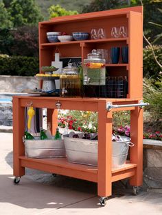 an outdoor kitchen cart with pots and pans on it's shelf, filled with food