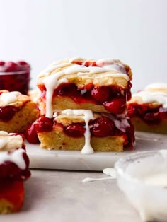 strawberry shortcakes stacked on top of each other with icing drizzled over them