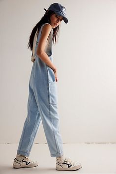 One-and-done and so simple, this denim jumpsuit from our We The Free Collection is featured in a relaxed fit and cropped ankle-length style with harem legs and a low scoop neckline. **Fit:** Slouchy, relaxed fit; ankle-length, pull-on style **Features:** Denim fabrication, rigid feel, low scoop neckline, seam detail throughout, oversized patch pockets, drop-crotch harem-style legs, low back with adjustable shoulder straps **Why We | We The Free High Roller Jumpsuit at Free People in Light Wash, Free People High Roller Jumpsuit Outfit, Free People High Roller Jumpsuit, High Roller Jumpsuit Outfit, Free People Jumpsuit Outfit, Free People Jumpsuit, Modest Clothes, High Roller, 2024 Style, Short Sleeve Romper