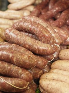 several sausages and potatoes are stacked on top of each other in this close up photo