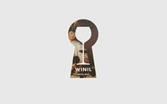 a key with the words winil on it and an image of a woman's face