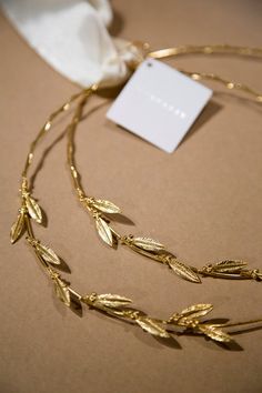 a gold necklace with leaves on it