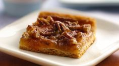 a square piece of food sitting on top of a white plate