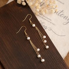 This earrings are a popular choice for bridal parties, they are really stylish and easy to wear. A fabulous piece of wedding jewelry for brides, bridesmaids, and the mother of the bride. FEATURES: Pearl Size: 2-3 mm Earring Length:6 cm/2.36'' Material: Natural Freshwater Pearls Finish: 18K Gold Plated Sold as a pair ----------------------------------- ATTENTION Please note that due to the natural origin of freshwater pearls, slight variations in color, size, and shape may occur. These variations add to the unique charm of each pair of earrings. ----------------------------------- PACKAGING A nice gift box is included, ready for gifts. If you have specific requests, please let me know. ----------------------------------- SHIPPING We appreciate every order you place with us. Please keep in m Pearl Earrings Real, Earrings Packaging, Real Pearl Earrings, Freshwater Pearl Earrings, Bridal Parties, Freshwater Pearls Earrings, Real Pearls, Earrings Dainty, Natural Pearl