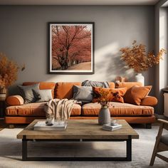 a living room with an orange couch and coffee table in front of a painting on the wall