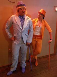 two people dressed in costumes standing next to each other