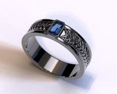 a ring with a blue stone in the center on a white surface, it looks like an intricate design