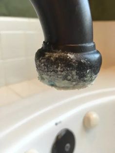 a black pipe sticking out of the side of a bathtub