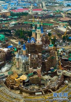 an aerial view of the amusement park with train tracks and buildings in the foreground