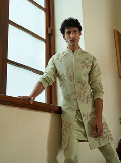 Celedon Sleeveless Sherwani - Contrast by Parth A perfect blend of asymmetrical placement embroidery over woven patterned fabric. Included in purchase: Jacket, Kurta and Pants Product Specification Color: Green (can be customized) Fabric: Jacquard Occasion: Formal Event, Wedding, Bridal, Reception Style: Sherwani Designer: Contrast by Parth Care: Dry Clean Only Work: Hand Embroidered Chikankari ( Variation in color, fabric & detail is possible. Model images are only representative.) This can be Green Sherwani For Men, Wedding Sherwani For Groom, Green Sherwani, Sherwani For Groom, Placement Embroidery, Sherwani Groom, Sherwani For Men, Wedding Sherwani, Indian Wedding Wear