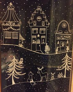 a black and white drawing of a christmas scene on a glass door with snow falling off the roof