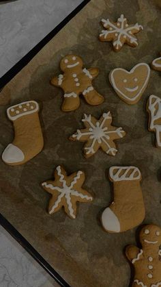 cookies decorated with icing and decorations are on a baking sheet, ready to be baked