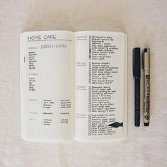 an open notebook and pen sitting on top of a table