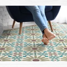 a woman is sitting on a chair with her feet up in front of the floor