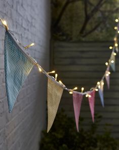 a string of lights hanging from a brick wall