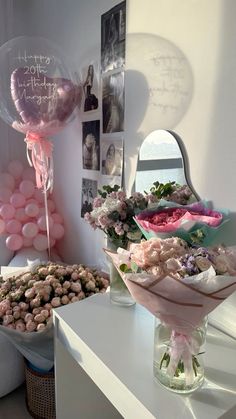 a bouquet of flowers and balloons on a table