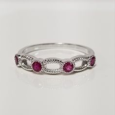 "Thanks for shopping our vintage estate store. We tend to sell well below wholesale and truly hope you enjoy all of our items. Many of the items are one of a kind, so please enjoy scrolling through the pictures and hopefully something will catch your eye. Brown spots are from camera or reflections. Beautiful estate 14k white gold round cut .20ct ruby band. There are 4 rubies for .20ct. Rubies are Burmese and stunning. Ring size: 7 Setting: 3.5mm 1/8\" Weight: 2.0 grams Band width: 1.5mm Marked 1 Classic Ruby Ring For Promise With Prong Setting, Classic Ruby Ring With Diamond White Prong Setting, Classic Ruby Ring With Prong Setting In Diamond White, Classic Ruby Ring Brilliant Cut For Promise, Classic Brilliant Cut Ruby Promise Ring, Classic 14k White Gold Ruby Ring, Classic Ruby Gemstone Stackable Rings, Classic Ruby Stackable Rings With Gemstones, Classic Round Ruby Promise Ring