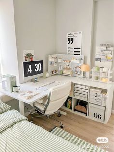 a white desk with drawers and a computer on it in a bedroom next to a bed