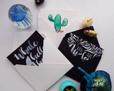 some paper with different designs on them and other items around it, including an ornament