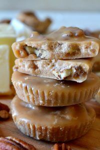 some pecan pies are stacked on top of each other with nuts around them