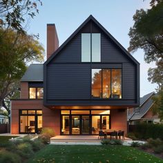 a large house with lots of windows and grass