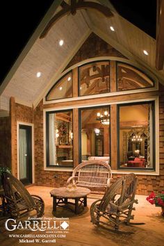 the porch is lit up with lights and furniture