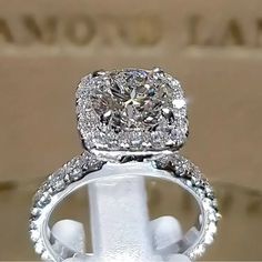 a close up view of an engagement ring with diamonds on it's sidestone