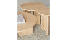 three wooden tables sitting on top of a carpeted floor