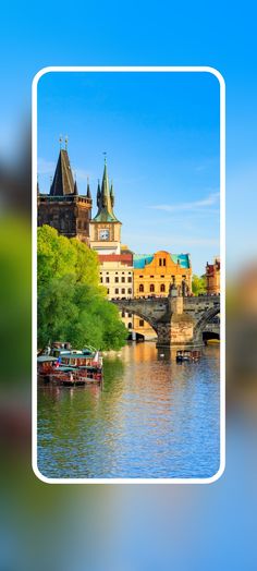 an image of a river with boats in the water and buildings on the other side