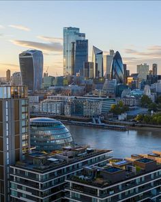 an aerial view of the city of london with skyscrapers and river thames in the foreground