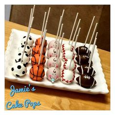 there are many cake pops on the plate with basketballs and tennis balls in them