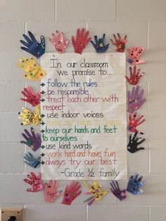 a bulletin board with handprints on it and words written in different colors that spell out the word