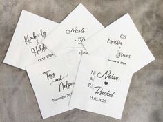 four personalized napkins with the names and date printed on them are laid out