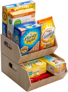 a wooden box filled with lots of different types of food and snacks on top of each other